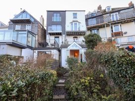 An outdoor view of a house with balconies and a garden at 13 Above Town in Dartmouth