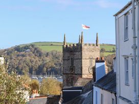 A church tower with a flag and hills in the background at 13 Above Town Dartmoor