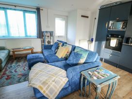 A living room with a blue sofa and coffee table at 7 Bro Branwen Aberffraw near Rhosneigr