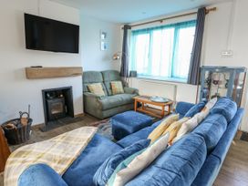 A living room with a television and sofa at 7 Bro Branwen Aberffraw near Rhosneigr