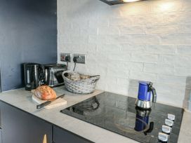 A kitchen with a kettle, toaster, and coffee pot at 7 Bro Branwen in Aberffraw near Rhosneigr