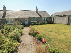 A house with a garden and pathway at 7 Bro Branwen Aberffraw near Rhosneigr