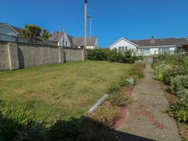 A garden with grass and flower bed at 7 Bro Branwen Aberffraw near Rhosneigr