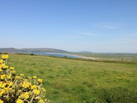 A view of the sea and grassy landscape at Sunstone (Garreg Haul) Cilan near Abersoch