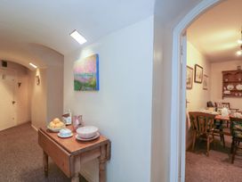 A hallway with a table and chair at Dollar Ward House Basement Cirencester
