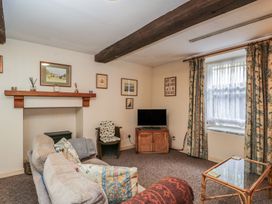 A living room with a sofa and television at Dollar Ward House Basement Cirencester