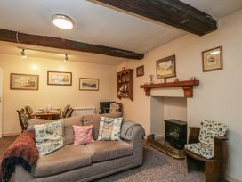 A living room with a fireplace and dining area at Dollar Ward House Basement Cirencester