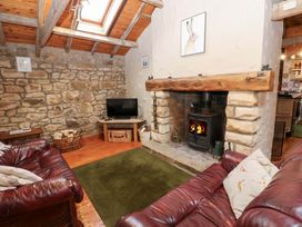 A living room with a fireplace and television at The Granary in Rothbury
