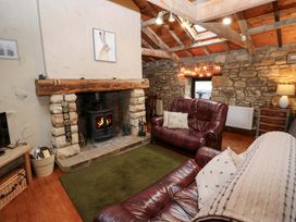 A living room with a fireplace and sofas at The Granary in Rothbury