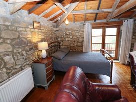 A bedroom with a bed and window at The Granary in Rothbury