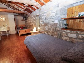 A bedroom with two beds and furniture at The Granary in Rothbury