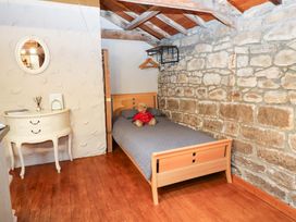 A bedroom with a bed and a teddy bear at The Granary in Rothbury