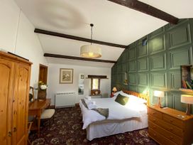 A bedroom with a bed and furniture at Swaledale Watch Garden Annexe in Caldbeck