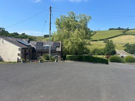 An outdoor area with solar panels and trees at Swaledale Watch Garden Annexe Caldbeck
