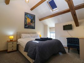 A bedroom with a bed and a television at Cefnbron Llanaelhaearn near Trefor