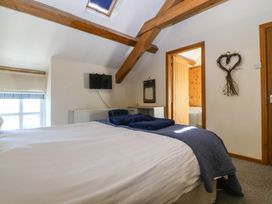 A bedroom with a bed and television at Cefnbron in Llanaelhaearn near Trefor