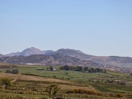 A landscape featuring mountains and fields at Cefnbron, Llanaelhaearn near Trefor