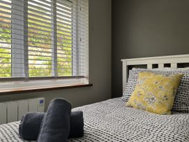 A bedroom with a bed and decorative pillow at Stonecroft in Praa Sands