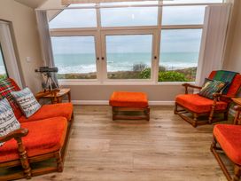 A living room with chairs and a telescope at Stonecroft in Praa Sands