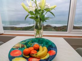 A bowl with fruit and flowers on a table at Stonecroft in Praa Sands