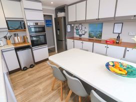 A kitchen with appliances and dining table at Stonecroft in Praa Sands