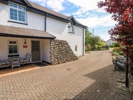 An outdoor area with chairs and a table at The Stables in St Athan