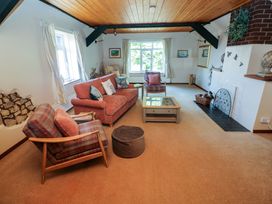 A living room with seating and a fireplace at The Stables in St Athan