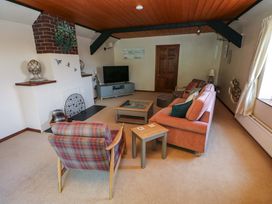 A living room with a sofa and armchair at The Stables in St Athan