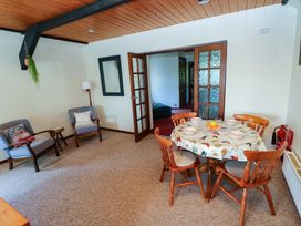 A dining room with a table and chairs at The Stables in St Athan