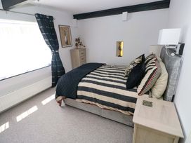 A bedroom with a bed and bedside table at The Stables in St Athan