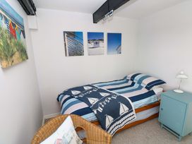 A bedroom with a bed and wall art at The Stables in St Athan