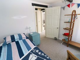A bedroom with a bed and nightstand at The Stables in St Athan