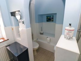 A bathroom with a toilet and sink at The Stables in St Athan