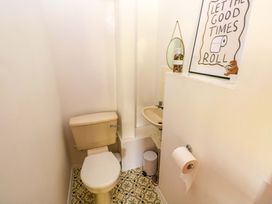 A bathroom with a toilet and a sink at The Stables in St Athan