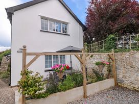 An outdoor area with a table and umbrella at The Stables in St Athan