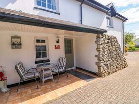 An outdoor patio with chairs and a table at The Stables St Athan