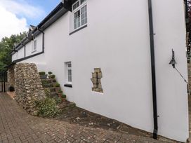 An outdoor image showing a building with a stone wall and steps at The Stables in St Athan