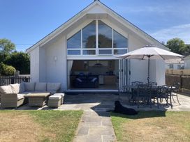 A patio area with seating and an umbrella at Awel Deg, Newport