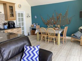 A dining room with a table and chairs at Awel Deg, Newport