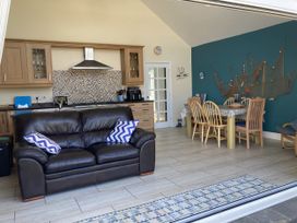 A living room with a kitchen area at Awel Deg, Newport, Pembrokeshire
