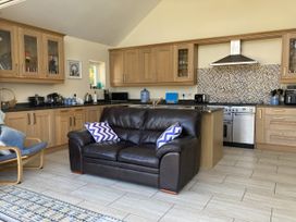A kitchen with a sofa and cabinets at Awel Deg, Newport