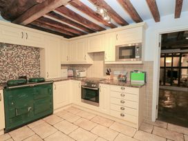 A kitchen with cabinets and a green oven at Butlers Cottage in Burford