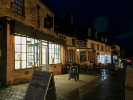 An outdoor view of Burford Library in Burford with tables and chairs outside