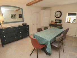 A dining room with a table and chairs at Black Horse Cottage in Swainby