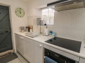 A kitchen with appliances and countertop at Black Horse Cottage in Swainby