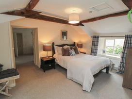 A bedroom featuring a bed and window at Black Horse Cottage Swainby