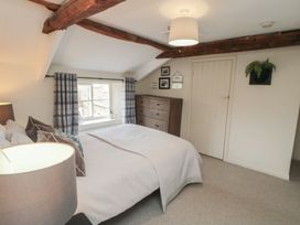 A bedroom with a bed and a dresser at Black Horse Cottage in Swainby