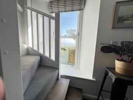 A staircase with a window and plant at Moorhurst Cottage in Kents Bank near Grange-Over-Sands
