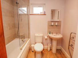 A bathroom with a bathtub, toilet, and sink at Greenbank Cottage in Winster near Bowness-On-Windermere