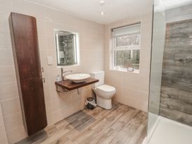 A bathroom with a sink, toilet, and shower at Greenbank Cottage in Winster near Bowness-On-Windermere